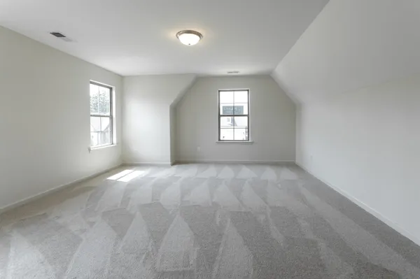 an empty room with windows and closet