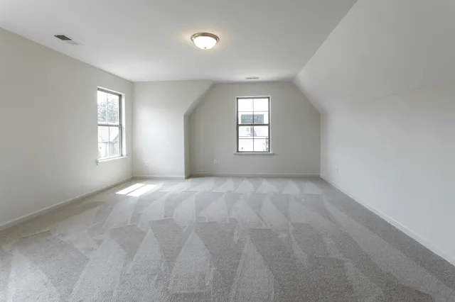 an empty room with windows and closet