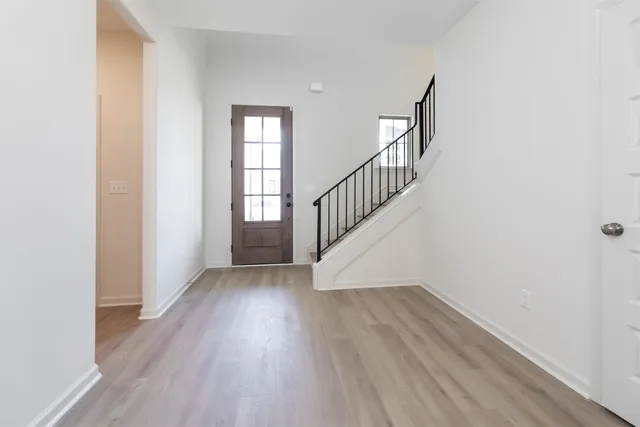 a view of hallway with wooden floor