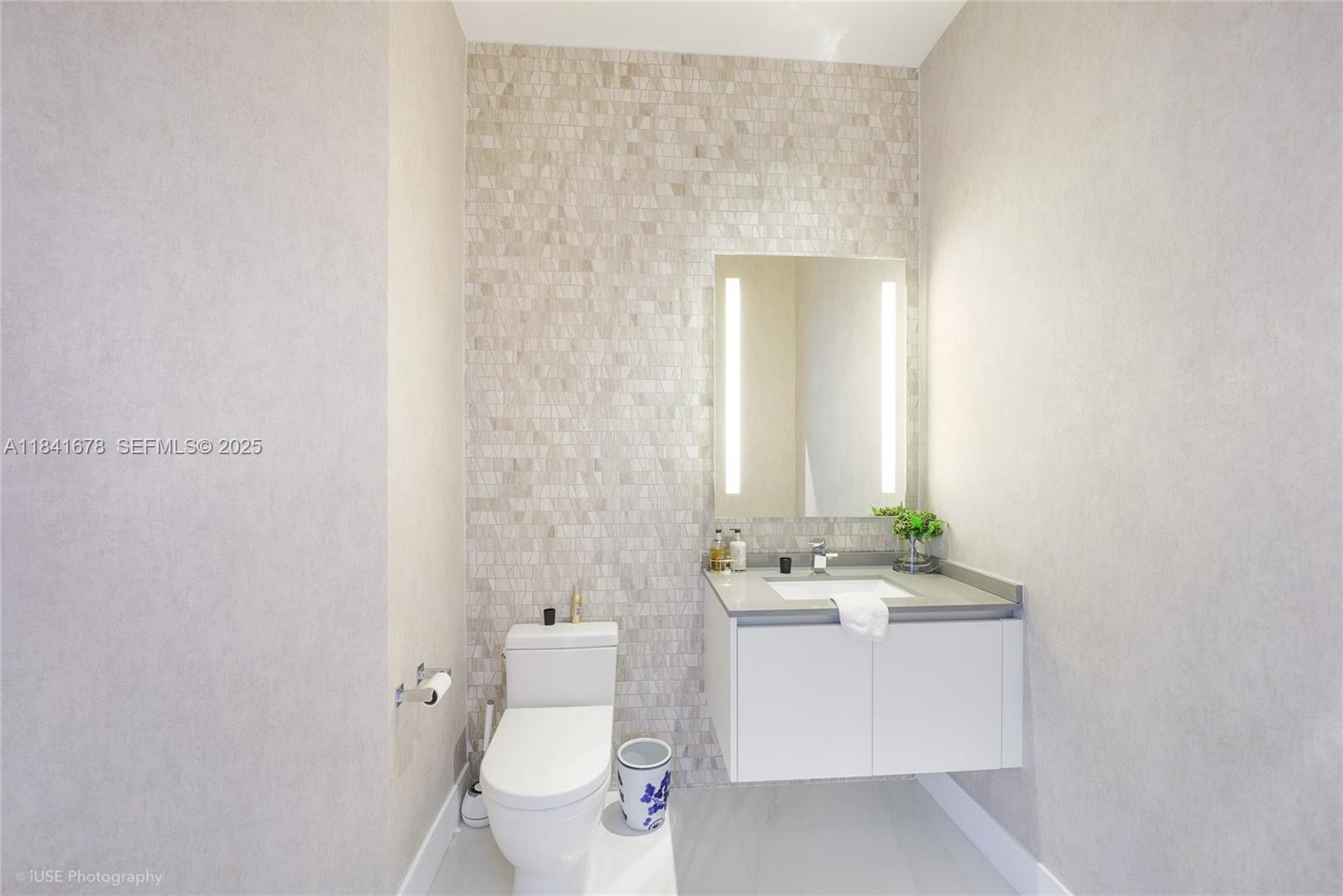 88 Southwest 7th Street, Unit 4101 Miami, FL 33130 - Photo 12 of 35 a bathroom with a sink a toilet and mirror