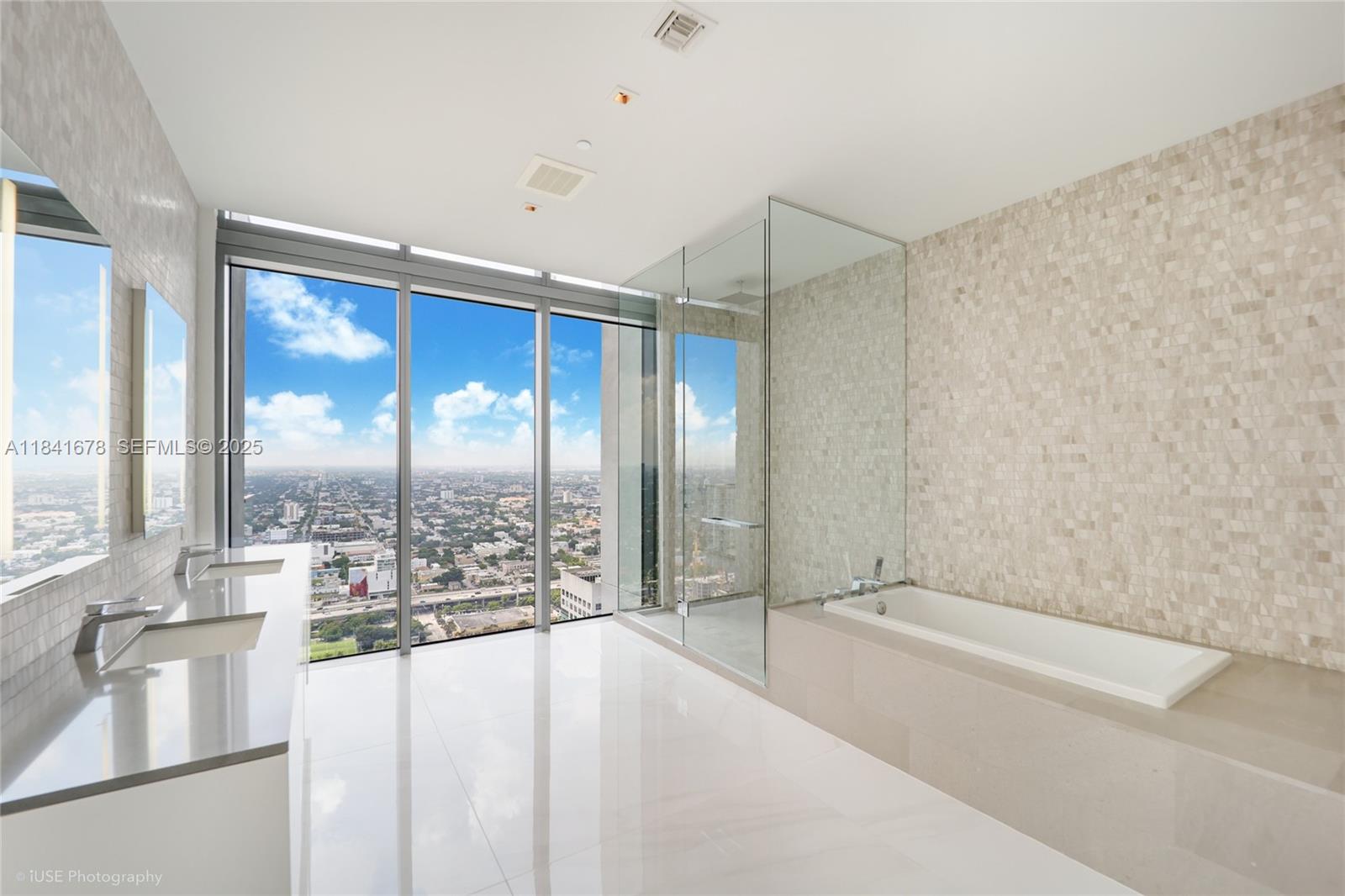 88 Southwest 7th Street, Unit 4101 Miami, FL 33130 - Photo 20 of 35 a spacious bathroom with a large tub and shower