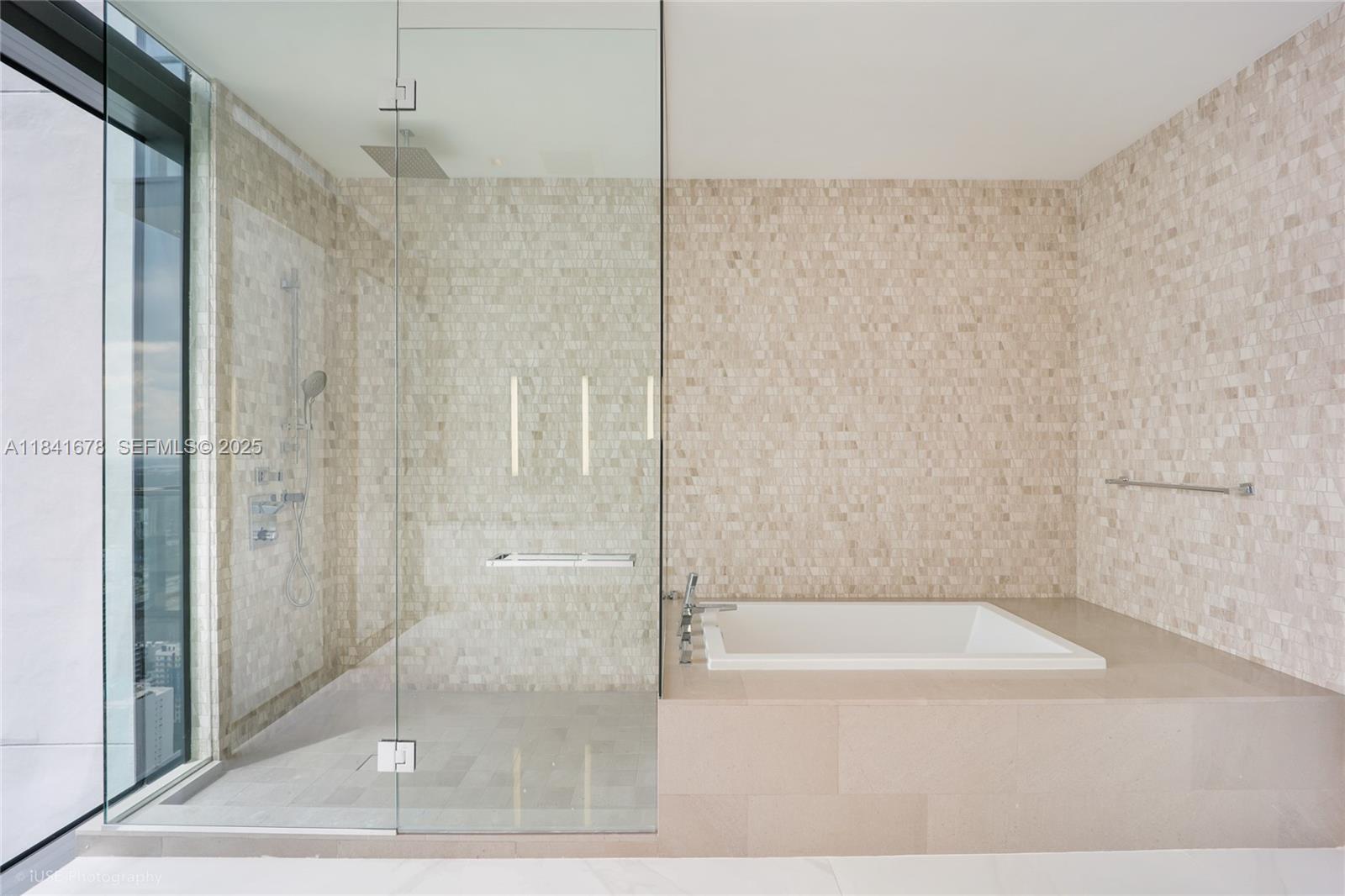 88 Southwest 7th Street, Unit 4101 Miami, FL 33130 - Photo 22 of 35 a bathroom with a bathtub and a shower