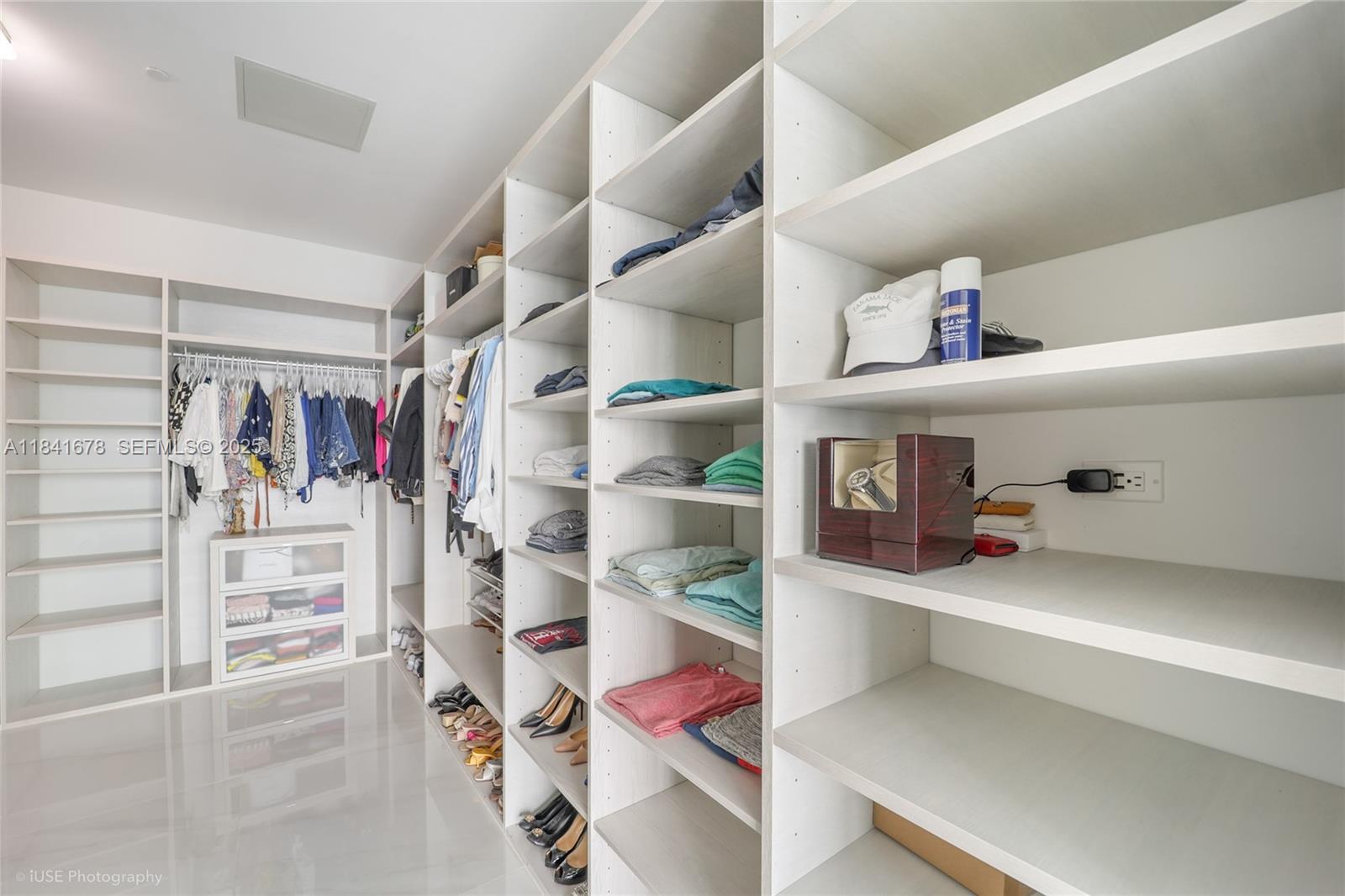 88 Southwest 7th Street, Unit 4101 Miami, FL 33130 - Photo 25 of 35 a view of walk in closet with clothes and shoes