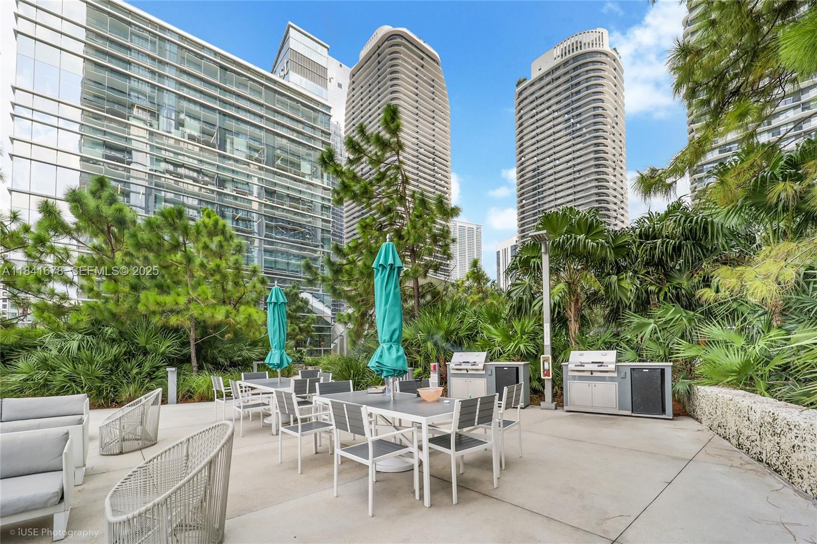 88 Southwest 7th Street, Unit 4101 Miami, FL 33130 - Photo 33 of 35 a view of a patio with table and chairs and potted plants