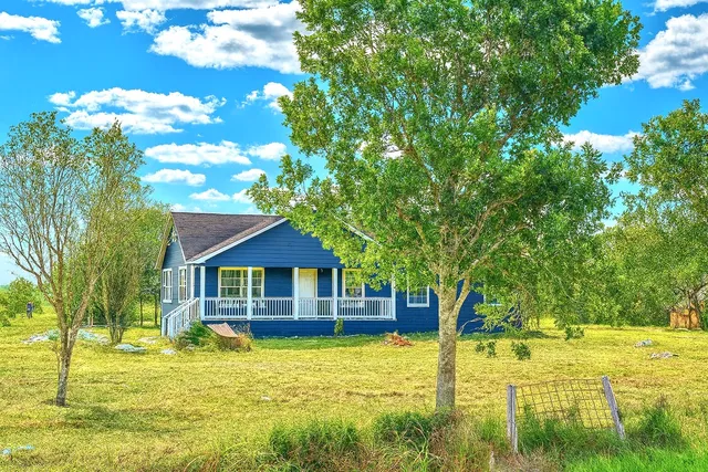 a front view of a house with swimming pool having outdoor seating