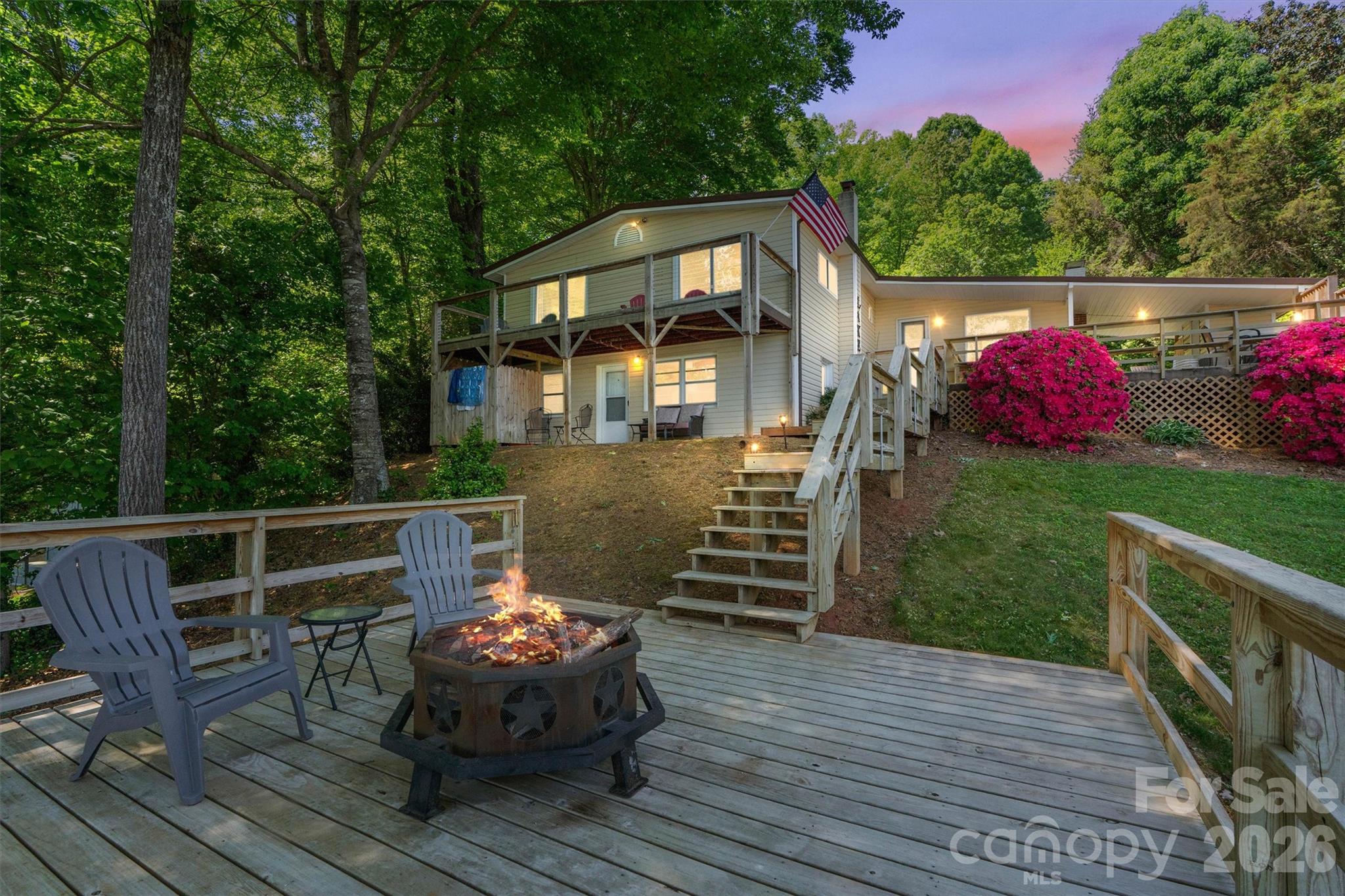 a front view of house with deck outdoor seating and yard