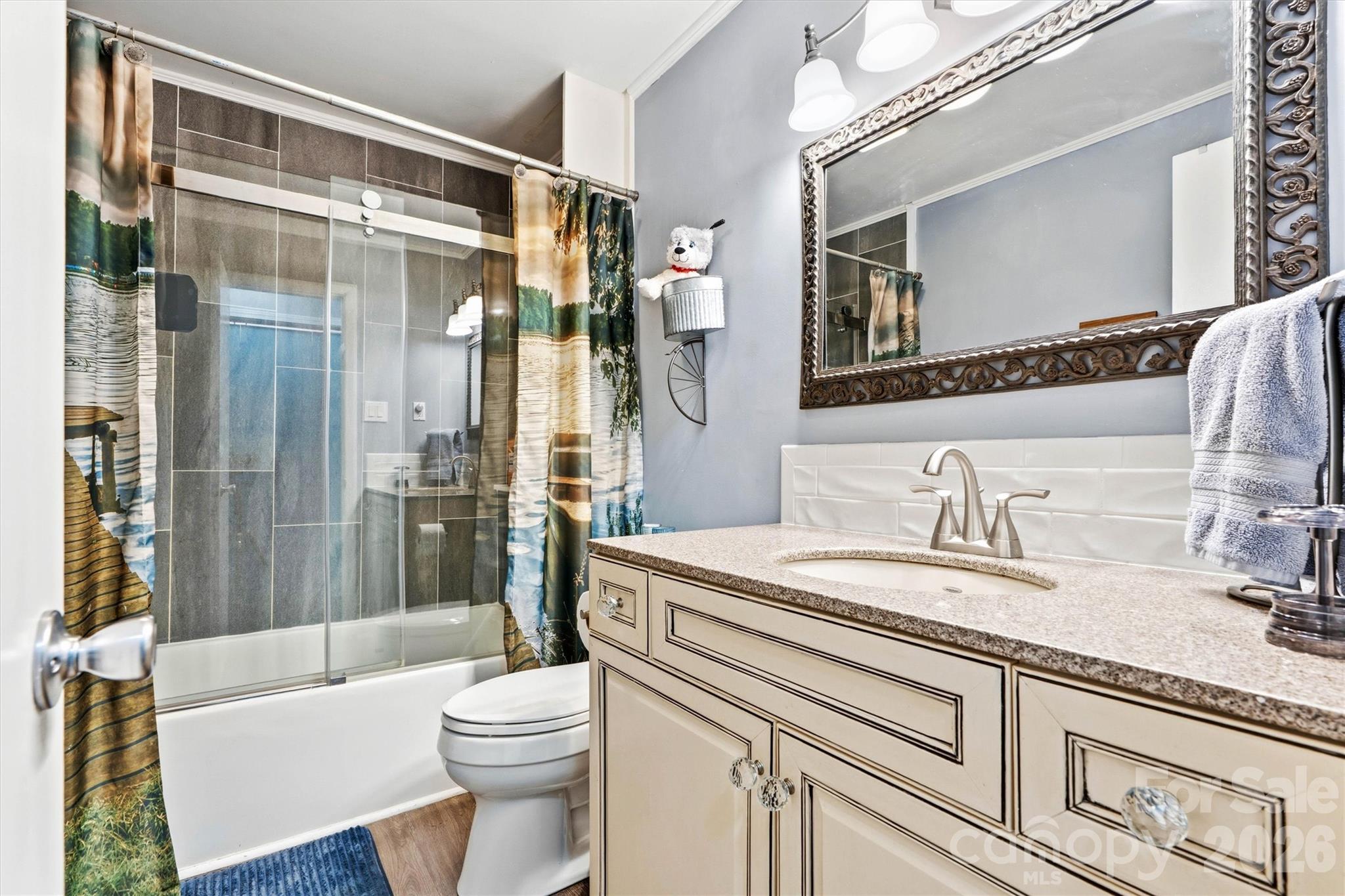 6566 Harbor Lane Conover, NC 28613 - Photo 24 of 43 a bathroom with a sink a toilet a mirror a bathtub and shower