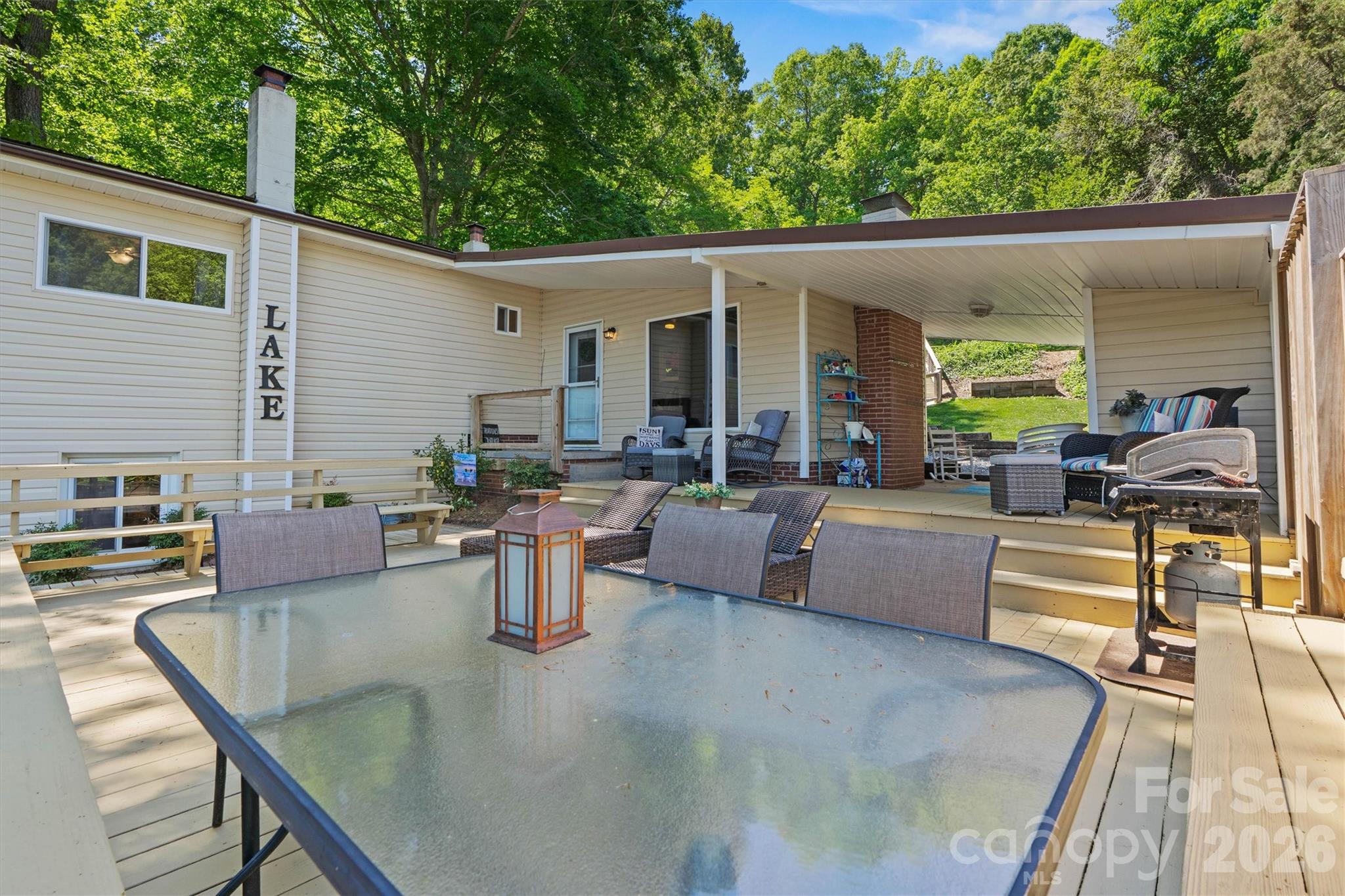 6566 Harbor Lane Conover, NC 28613 - Photo 35 of 43 a view of a patio with couches table and chairs with wooden floor and fence