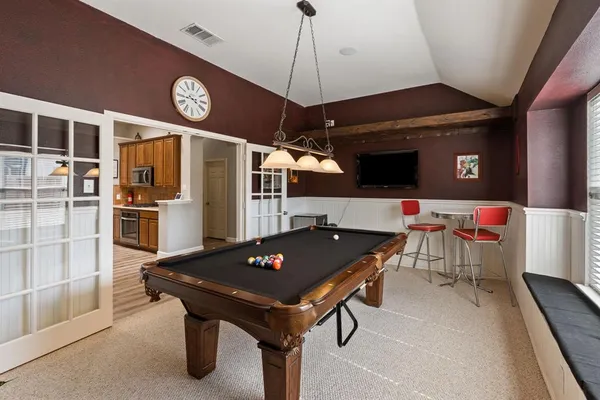 a room with furniture and stainless steel appliances