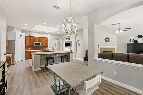 a kitchen with stainless steel appliances granite countertop a stove refrigerator and a sink