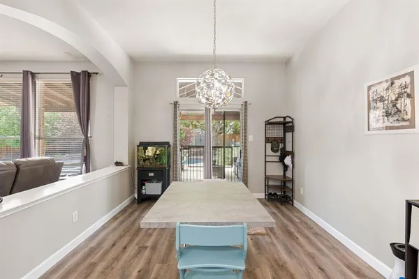 a spacious bedroom with a large bed and a chandelier