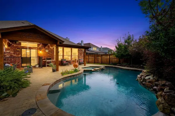 a view of a swimming pool with a lounge chair and garden