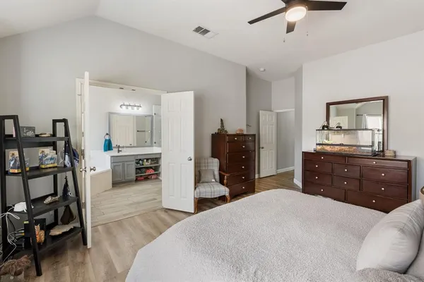 a bathroom with a sink vanity granite tub and shower