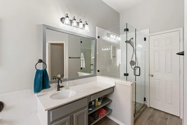 a bathroom with a tub sink and mirror