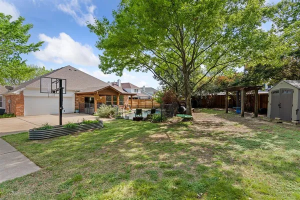 a view of a yard with a tree