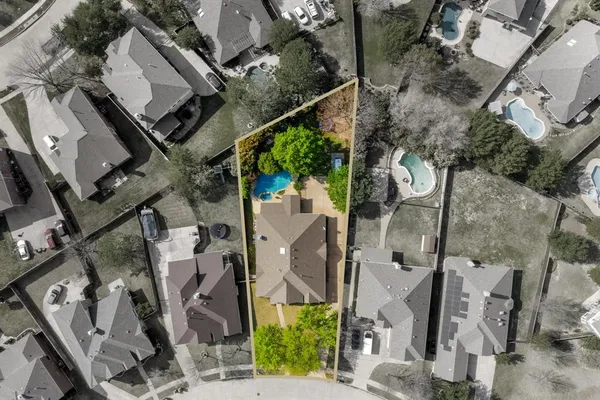 an aerial view of a house with a swimming pool