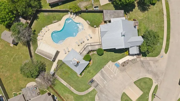 an aerial view of a house with garden space and street view