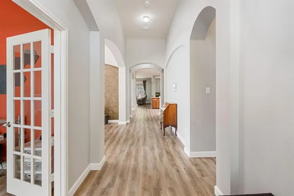 a view of a bedroom with wooden floor