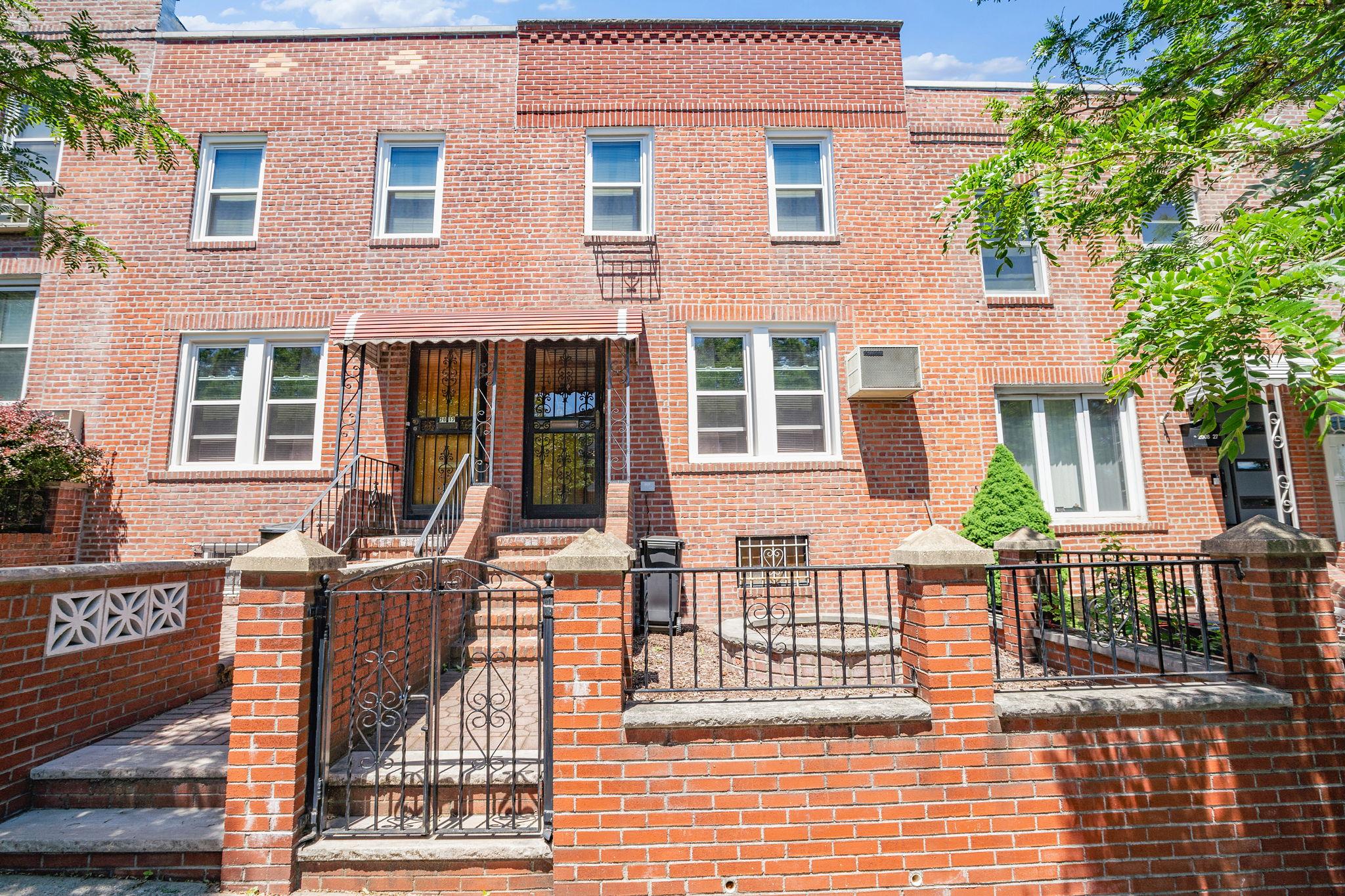 a view of a brick house with many windows