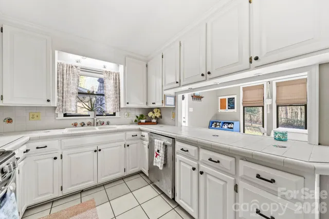 a kitchen with cabinets and window