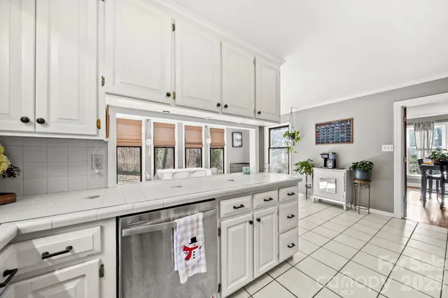 a living room with a large window and chairs