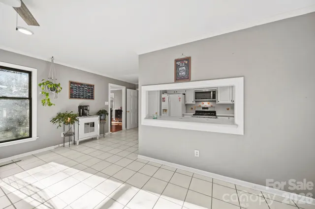 a view of a hallway with wooden floor and stairs