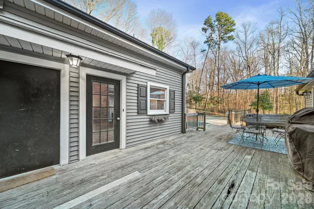 a patio with glass top table and chairs