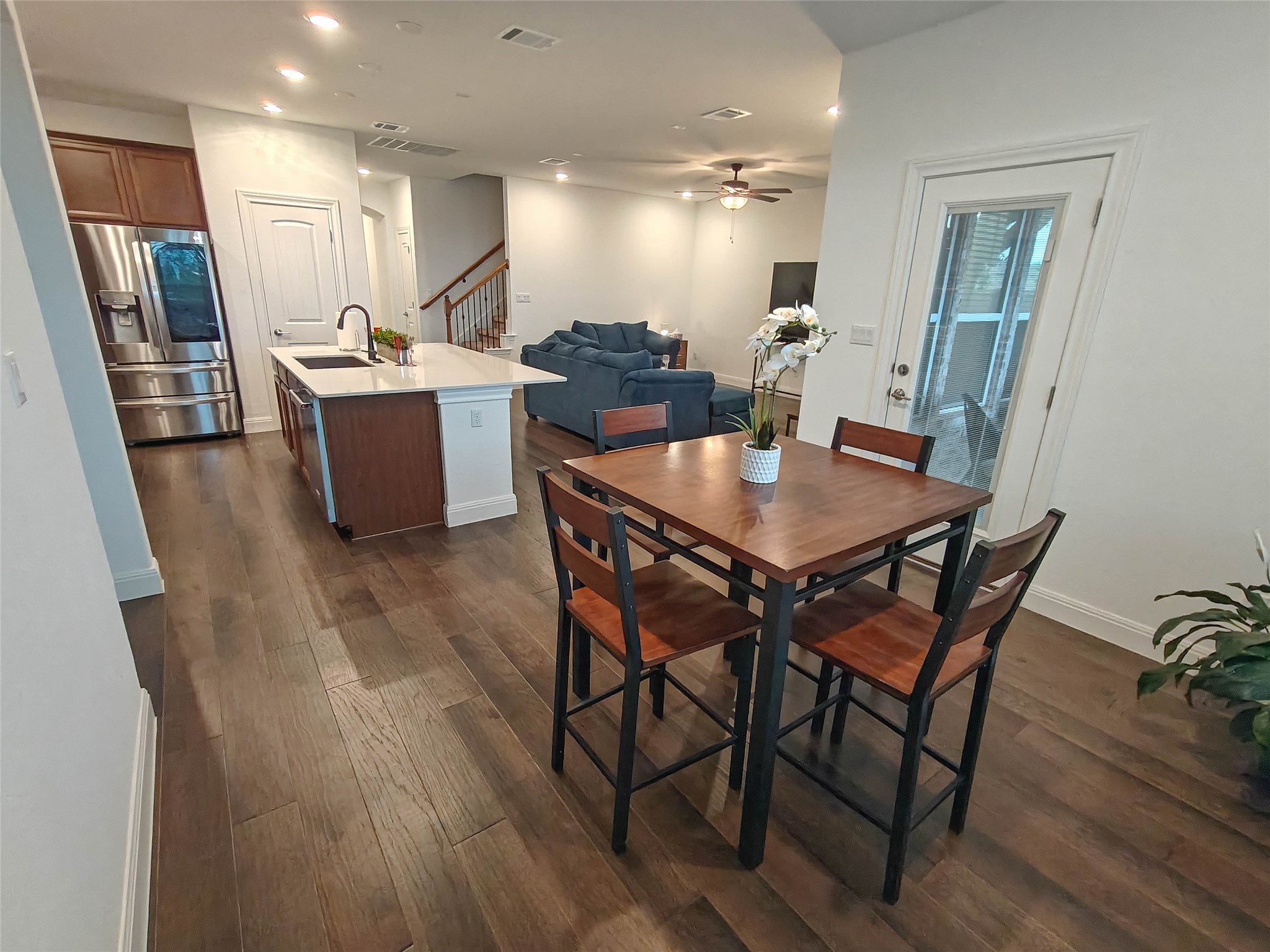 200 Fiddleneck Road Marble Falls, TX 78654 - Photo 9 of 37 a dining room with stainless steel appliances kitchen island granite countertop a table chairs and a refrigerator