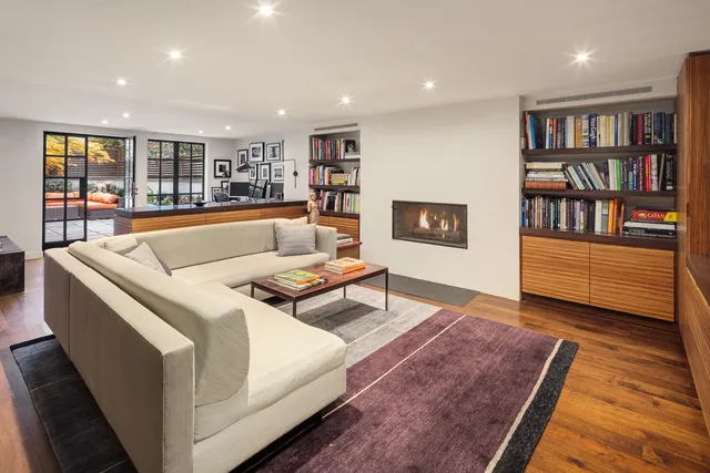 a living room with furniture and a book shelf