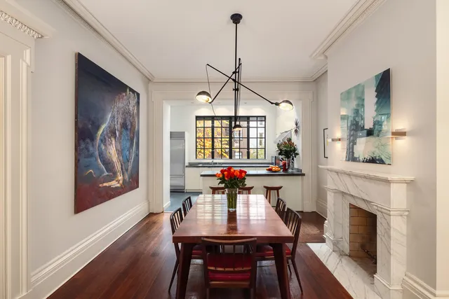 a living room with furniture fireplace and a window