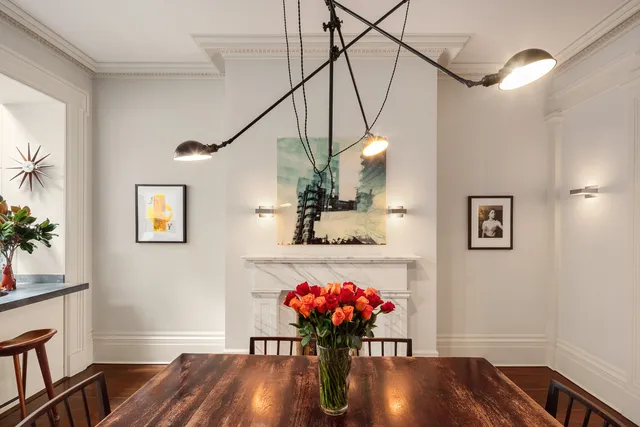 a dining room with furniture a chandelier and wooden floor