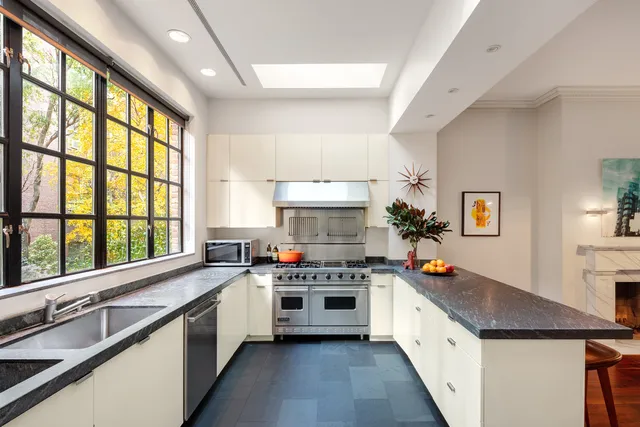 a kitchen with a stove a sink and a refrigerator