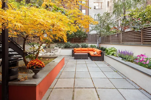 a backyard of a house with outdoor seating