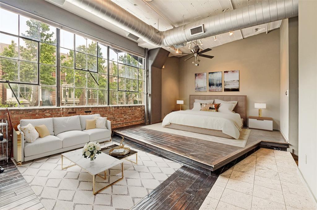 2220 Canton Street, Unit 101 Dallas, TX 75201 - Photo 5 of 20 Spacious loft-style interior with exposed brick and ductwork, featuring a wall of industrial-style windows