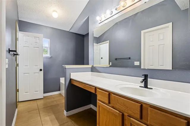 a room with sink and mirror