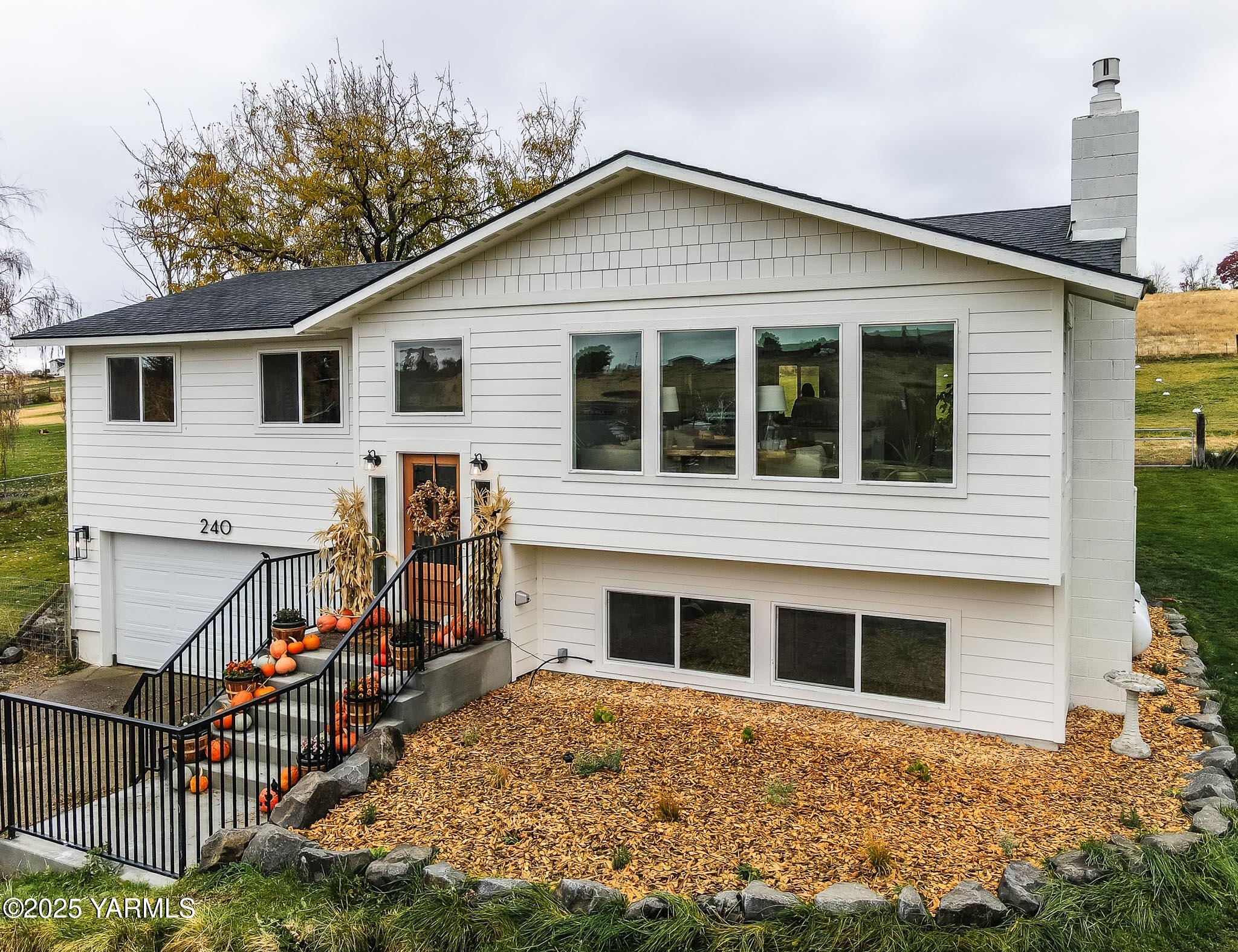 a view of a house with wooden fence and large windows