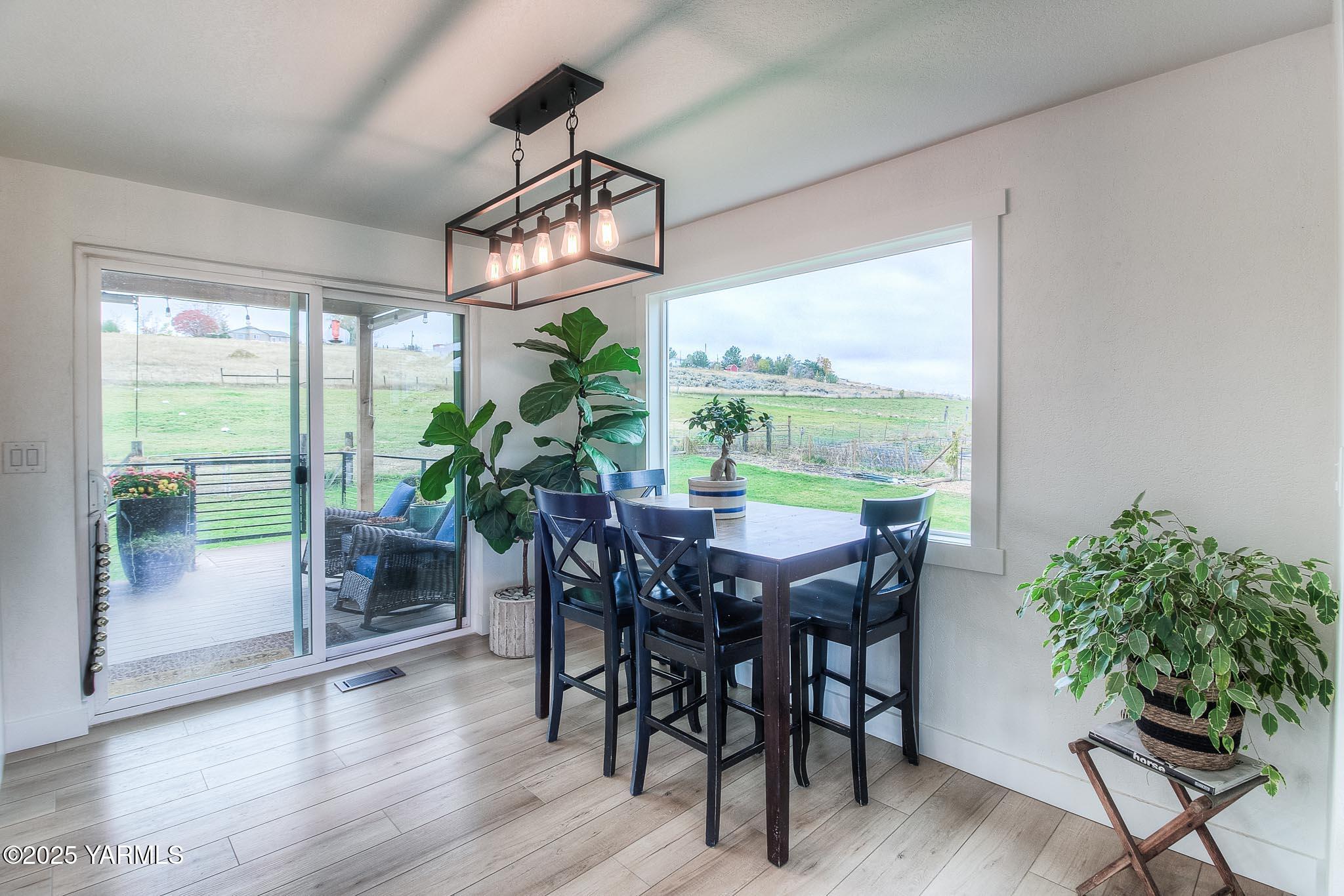 240 Knoll Road Yakima, WA 98908 - Photo 14 of 47 a view of a dining room with furniture window and wooden floor