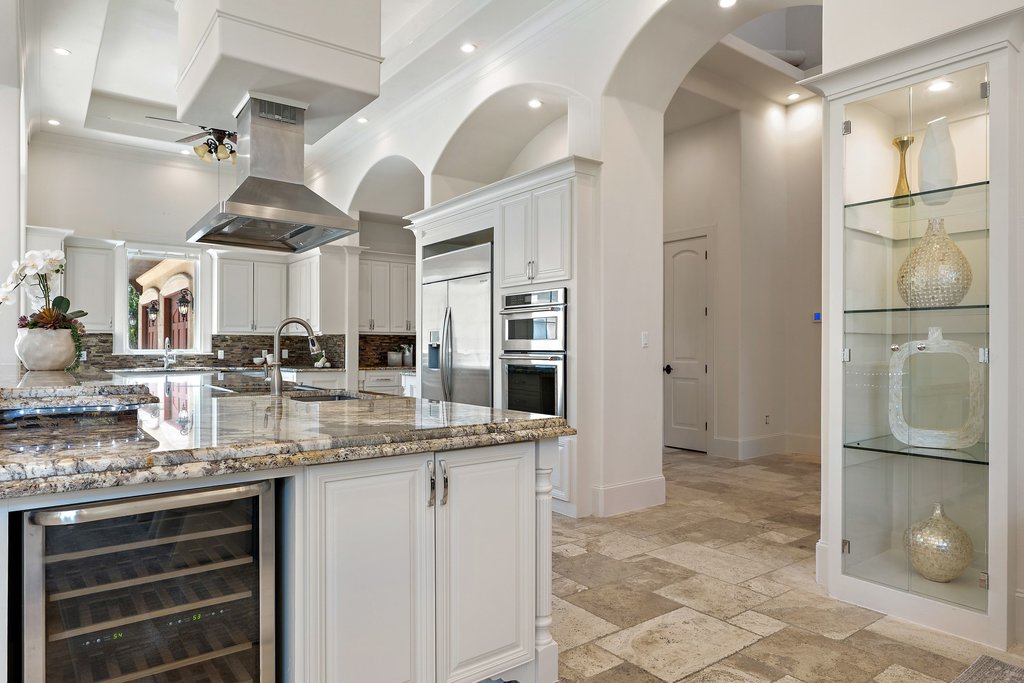 102 Long Point Cove Georgetown, TX 78628 - Photo 10 of 36 a kitchen with stainless steel appliances granite countertop a sink and a refrigerator