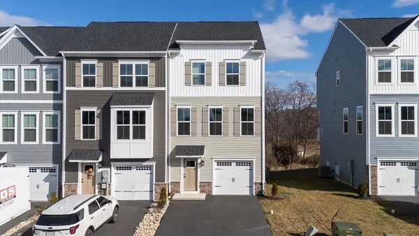 a front view of a building with a yard