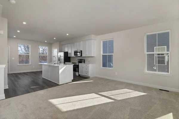 a view of kitchen with windows and refrigerator