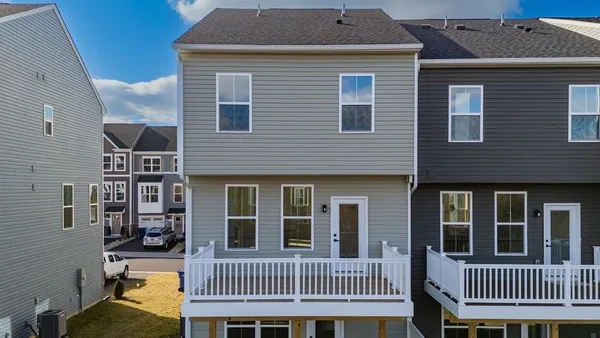 a view of a brick house with a deck