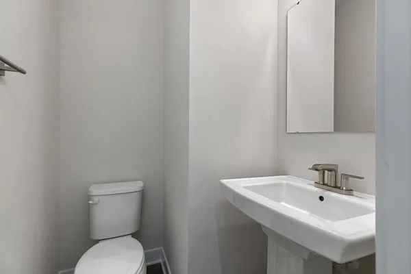 a white toilet sitting next to a white sink