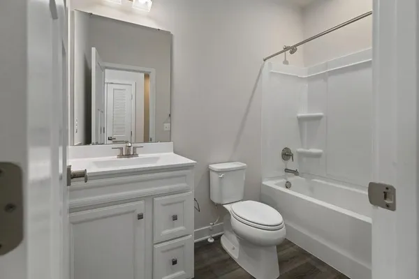 a view of a hallway with wooden floor and closet