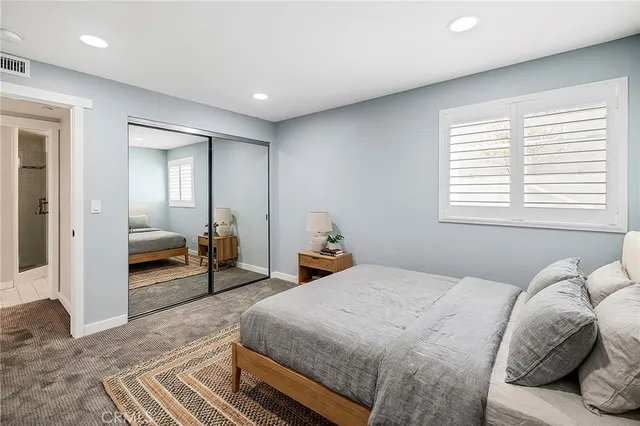 a bathroom with a shower sink vanity mirror and toilet
