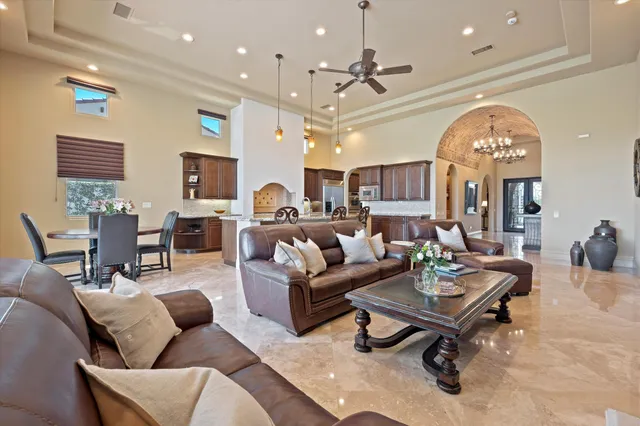 a view of a dining room with furniture and a chandelier