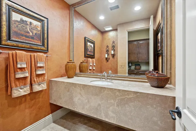 a spacious bathroom with a double vanity sink and a mirror