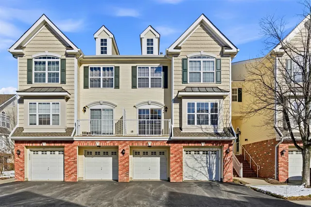 a view of a brick house with large windows