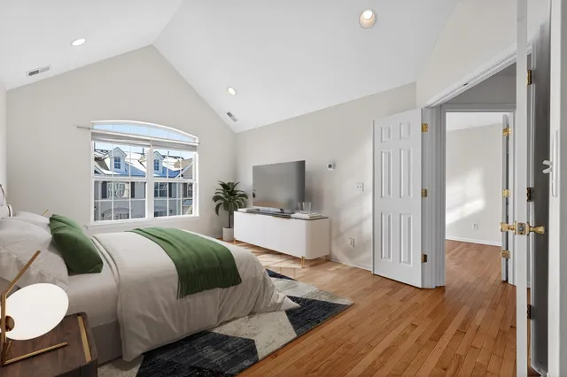 a bedroom with a bed and wooden floor