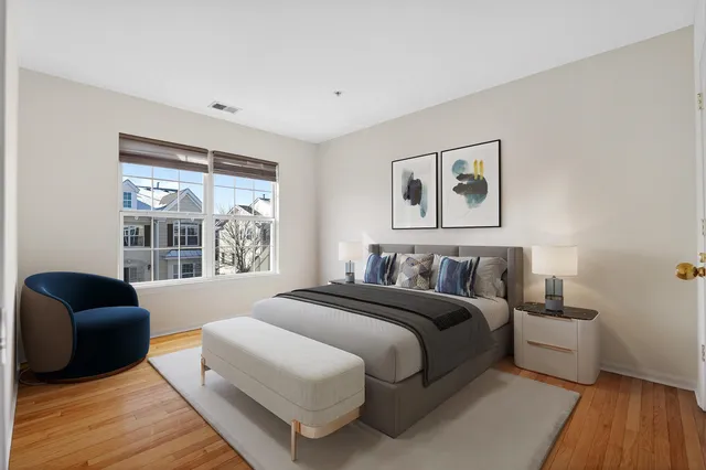 a bedroom with a bed and a large window