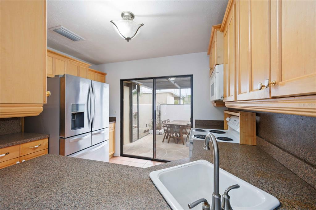 2767 Horseshoe Court, Unit Q3 Sarasota, FL 34235 - Photo 17 of 49 a living room with furniture a large window and flat screen tv